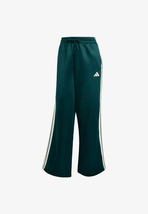 Grønne sweatpants med en afslappet pasform, elastisk talje og snøre. Har hvide sidestriber og et lille hvidt logo på benet.