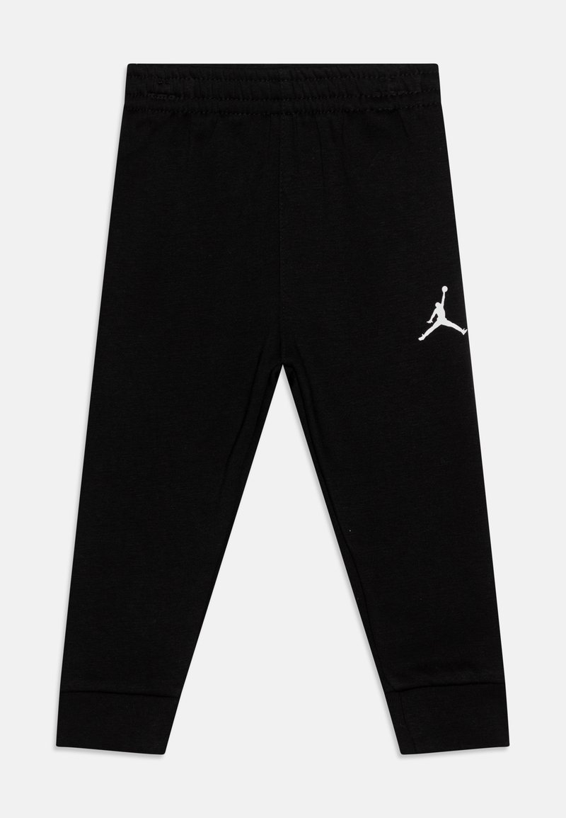 Leggings neri in cotone con vita elasticizzata. Presentano un logo Jumpman bianco sulla coscia sinistra. Design aderente con polsini alla caviglia.