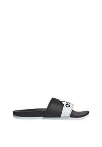 Infradito in gomma nera con una fascia bianca con logo nero. Suola piatta, texture liscia, punta arrotondata, design minimalista.