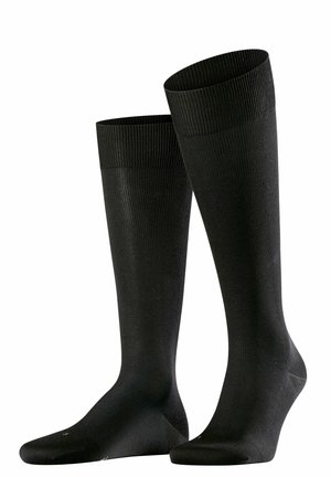 Sorte knæhøje strømper lavet af ribbet materiale. Glat overflade med forstærket tå, elastisk bånd øverst for sikker pasform. Ingen mønstre eller accenter.
