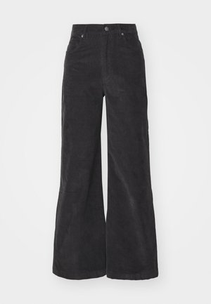 Black corduroy wide-leg trousers with a high waist, front pockets, and a button closure. The fabric features a soft, textured surface.