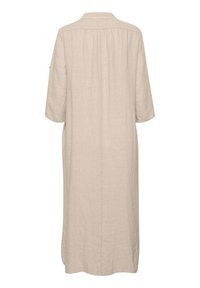 Beige linen dress with a collar, short sleeves, and back pleats. Features side pockets and a straight silhouette, with a smooth texture.