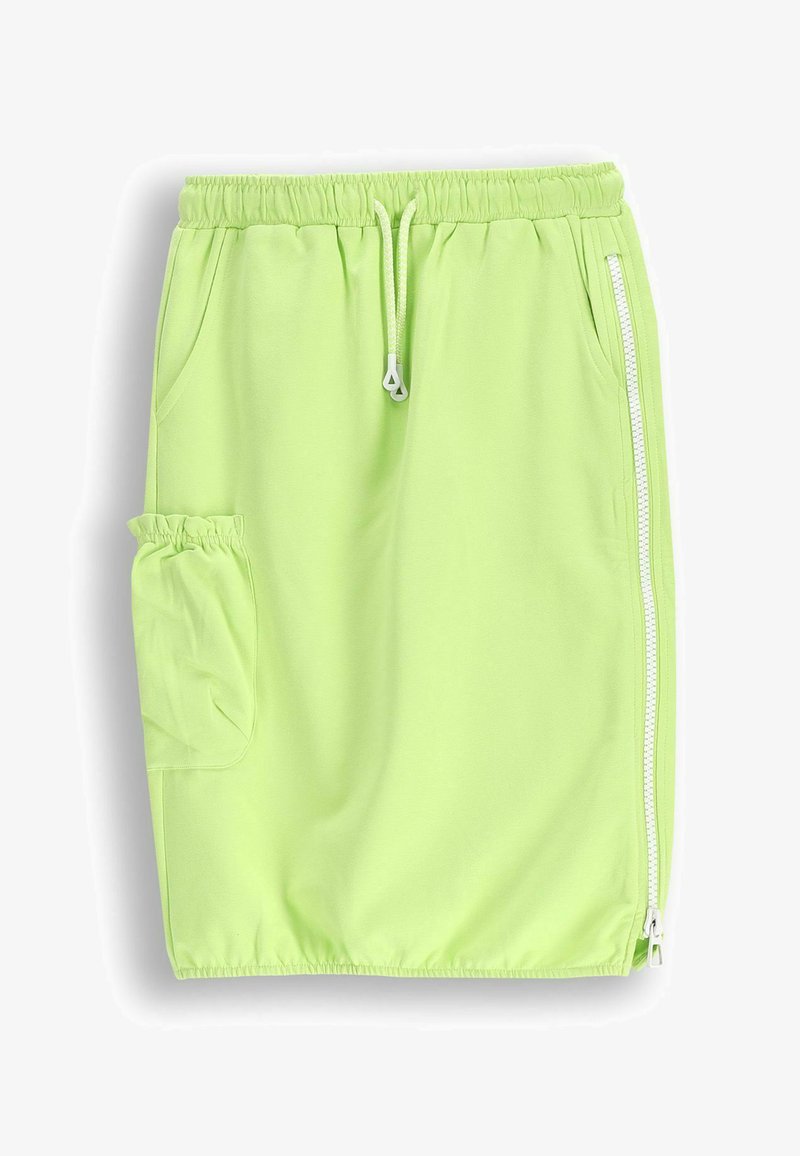Jasnozielona spódniczka sportowa uszyta z miękkiego, elastycznego materiału. Wyposażona w elastyczny pas, sznurek, boczny zamek błyskawiczny oraz boczną kieszeń.