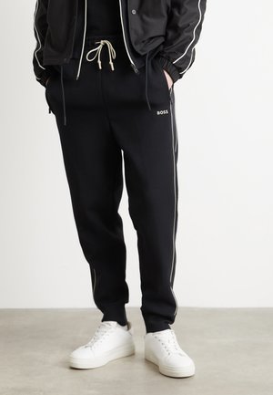 HADIKO  - Tracksuit bottoms - black