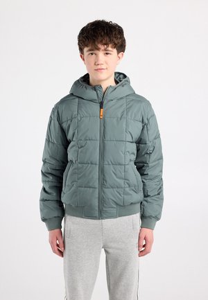 Padded green jacket with a hood, featuring a zip closure and ribbed cuffs. The design includes a quilted texture and orange accent on the zipper.