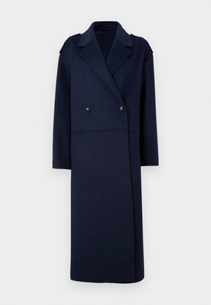 Manteau en mélange de laine bleu marine avec un devant double boutonnage, un col cranté et des manches longues. Il comporte deux boutons noirs et une coupe mi-longue.