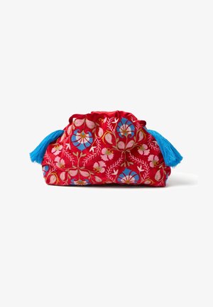 Bolsa de tela roja con bordado floral en rosa y azul, parte superior fruncida y borlas azul brillante a cada lado, sobre un fondo blanco.