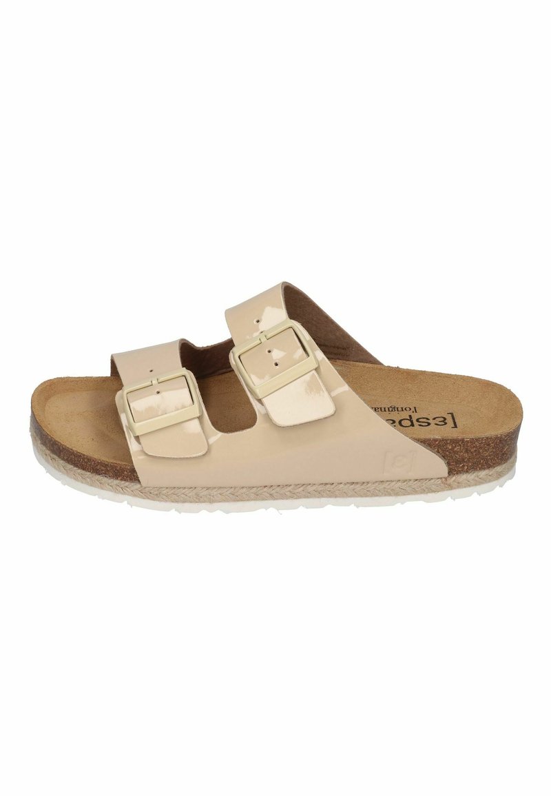 Beige slip-on sandal with two adjustable buckles, cork footbed, and textured rubber sole. Smooth upper material with a glossy finish.