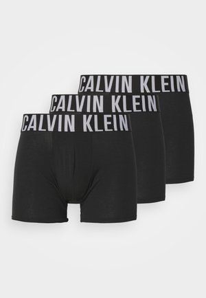 Tres pares de calzoncillos bóxer negros con una ancha cintura gris de Calvin Klein. Tejido suave, diseño ajustado y sin patrones ni acentos visibles.