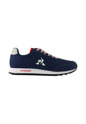 Navy blue athletic sneaker with white and red laces, white sole, and "le coq sportif" logo on side and heel tab.