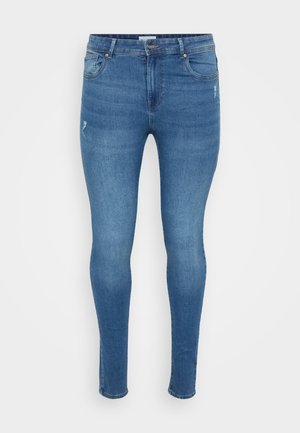 Jeans skinny em denim azul médio, com um clássico design de cinco bolsos, ligeiras desgastes na frente e costuras em contraste.