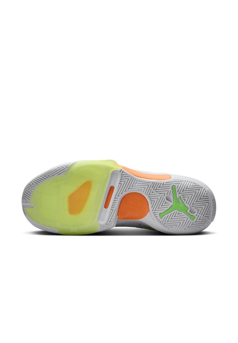 Suela de zapatilla deportiva blanca con patrón de espiga, que presenta acentos vibrantes en verde y naranja, y una sección amarilla translúcida.