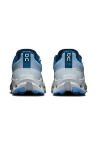 Blue and white running shoes featuring a textured mesh upper, a cushioned sole, and a rubber outsole with patterned tread.