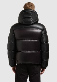 Black puffer jacket with a hood, featuring a glossy finish and quilted texture. Elastic cuffs and a sleek design emphasize warmth and comfort.