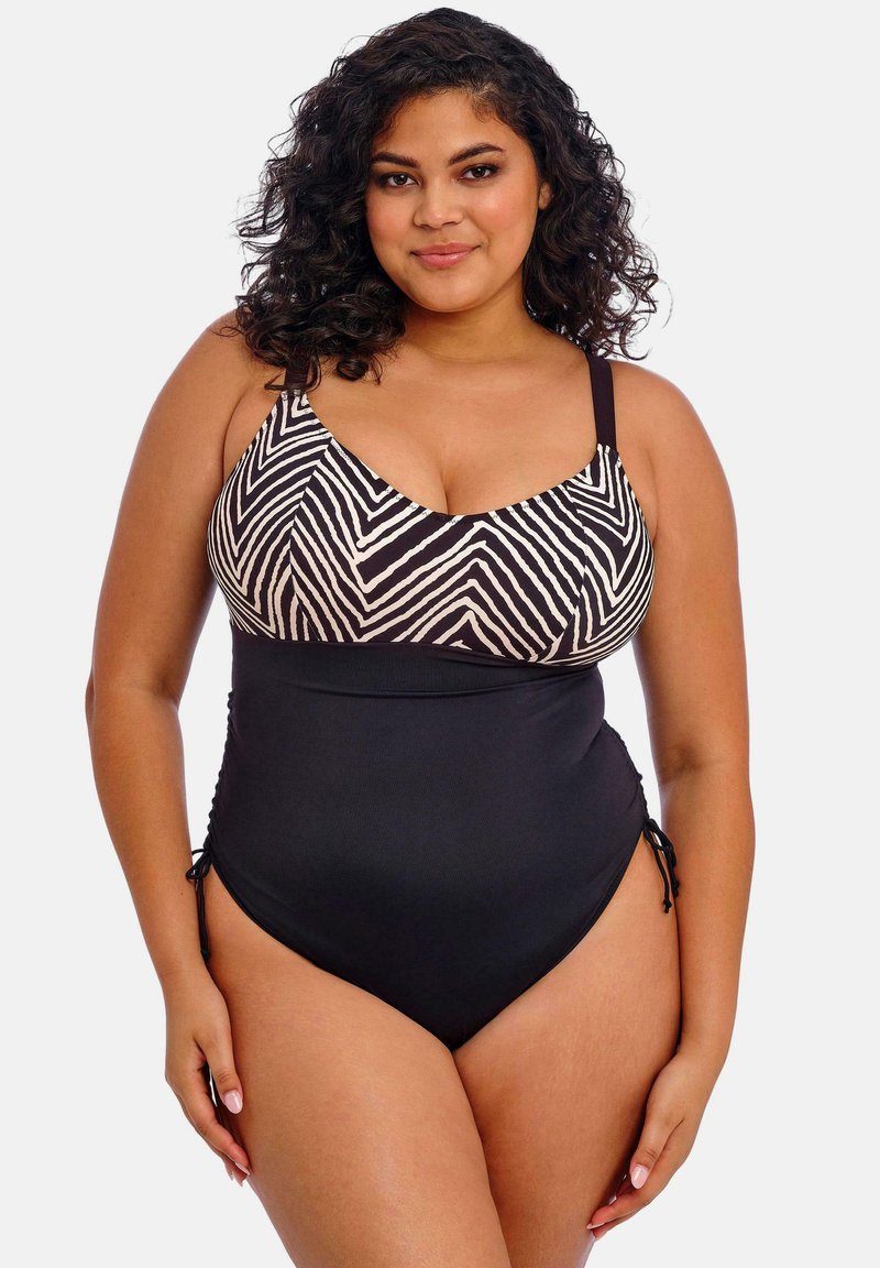 Maillot de bain une pièce noir avec un haut à motifs zèbre. Il dispose de bretelles réglables et d'un drapé sur les côtés pour une silhouette flatteuse.