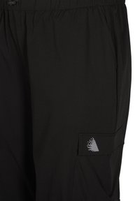 Black pants made of lightweight fabric. Features an elastic waistband, side pockets, and a cargo pocket with a white geometric logo.