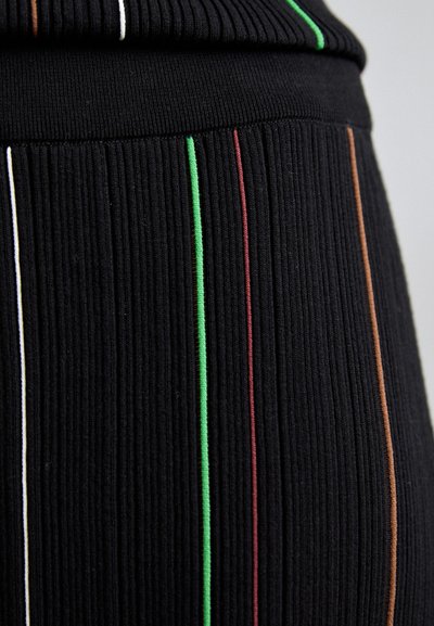 Țesătură neagră cu dungi verticale în alb, verde, roșu și marron. Textura este moale și elastică, potrivită pentru îmbrăcăminte ajustată.