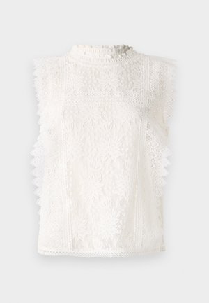 Witte kanten mouwloze top met een hoge ruches kraag, bloemenpatronen en gegolfde randen voor extra textuur en detail.