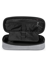 Gray fabric organizer case with a dark interior, zippered closure, and interior mesh pocket. Features elastic straps for item storage.