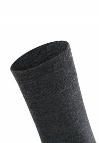 Calzino grigio scuro con una texture liscia e una parte superiore a coste, caratterizzato da un design a metà polpaccio e una costruzione senza cuciture per il massimo comfort.