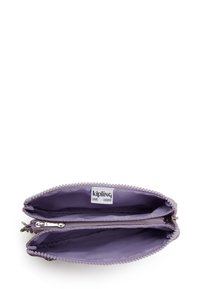 Light purple zippered wallet featuring two compartments, textured edges, and a small label inside with "kipling LIVE LIGHT."