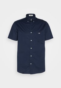 Navy blue short-sleeve button-up shirt with buttoned collar and chest pocket featuring a small embroidered logo.