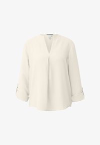 Blusa de manga larga de corte holgado en color crema, con abertura en forma de V en el cuello y puños arremangados.