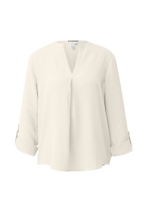 Blusa crema a maniche lunghe dal taglio ampio, con scollo a V e polsini risvoltati.