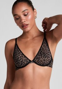 Leopard print bralette with black trim, featuring a soft, sheer fabric and triangle cups, adjustable straps, and a simple clasp at the back.