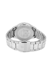 Montre en acier inoxydable argenté avec un bracelet à maillons, un boîtier rond et un fond transparent rond affichant des gravures. Comprend une couronne et un fermoir en métal.