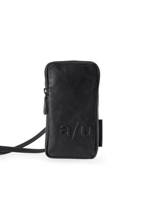 Black leather crossbody bag with a rectangular shape, featuring embossed letters and a zip closure, accompanied by a shoulder strap.