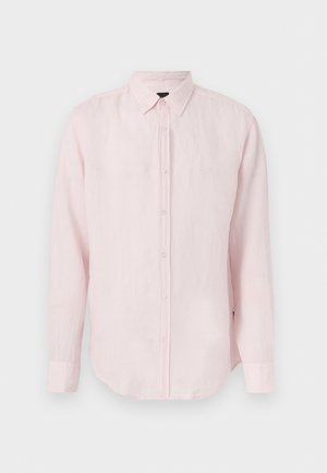 Chemise longue à manches longues rose clair avec col pointu, patte de boutonnage à l'avant et texture subtile du tissu sur fond uni.