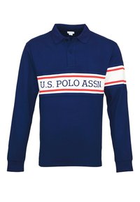 Tummansininen pitkähihainen polo-paita, jossa on valkoisia ja punaisia vaakaraitoja rinnassa ja hihassa, jossa on teksti "U.S. POLO ASSN."