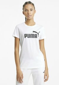 Valkoinen puuvillapaita, jossa on rohkea musta "PUMA" -logo ja siluetti rinnassa. Lyhyet hihat ja pyöreä pääntie.