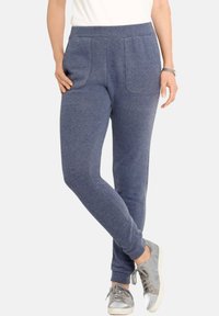 Marineblauwe joggingsbroek van een zachte stof, met een elastische tailleband, twee voorzakken en een taps toelopend ontwerp van de pijpen.