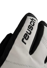 Close-up of black and white Reusch sports glove with brand name embroidered on the back of the hand.