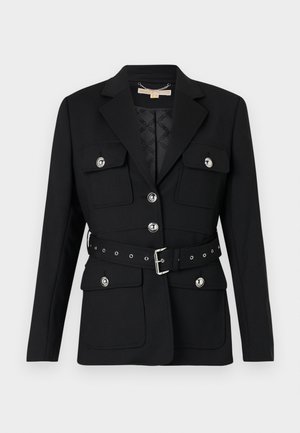 Μαύρο σακάκι με δύο μπροστινές τσέπες, ασημένιες λεπτομέρειες κουμπιών και ζώνη που τονίζει τη μέση με θηλιά και λεπτομέρειες γρόμμετ. Ραμμένο σε εφαρμοστό στυλ.