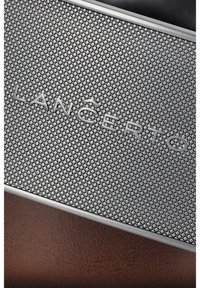 Teksturowany szary metalowy uchwyt na karty z wytłoczonym logo "LANCERTO", charakteryzujący się siatkowym wzorem i eleganckim designem, ustawiony na ciemnym tle.