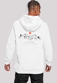 White hoodie featuring a mountain illustration with trees and a sun, accompanied by the text "ESCAPE AND DISCOVER THE WORLD."