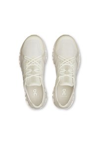Baskets blanches de sport avec tige en maille, bout rond et semelle rembourrée. La boîte à orteils arbore un logo ; les lacets sont fins et plats.
