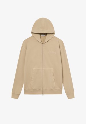 Sweatshirt à capuche zippé beige avec une poche avant et des poignets côtelés. Design minimaliste avec un texte brodé sur la poitrine. Matériau doux.