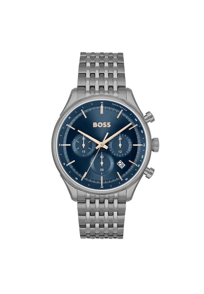 Montre chronographe avec bracelet en acier inoxydable, cadran bleu marine, accents dorés, sous-cadrans, affichage de la date et échelle tachymétrique.