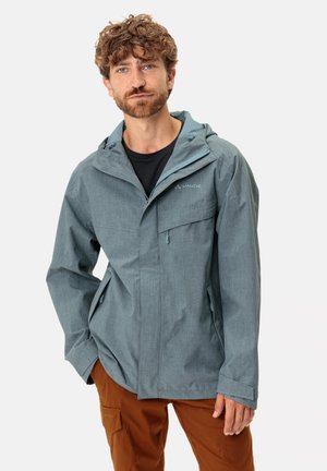 Light gray waterproof jacket with a hood, zippered pockets, and adjustable cuffs. Worn over a black shirt and brown pants.