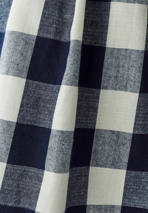 Blue and white checked fabric with a linen texture; features large alternating squares of varying shades of blue and ivory.