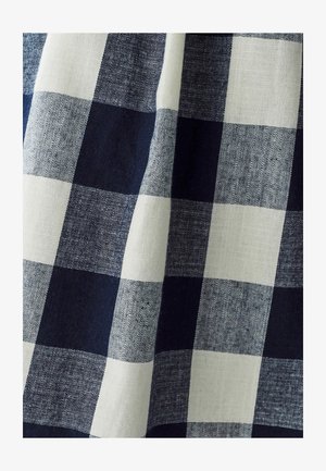 Blue and white checked fabric with a linen texture; features large alternating squares of varying shades of blue and ivory.