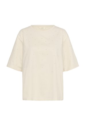 Lyhythihainen kermaan värinen T-paita, joka on tehty pehmeästä puuvillasta. Edessä pieniä rhinestone-koristeita hajallaan. Pyöreä kaula-aukko.