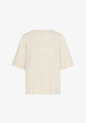 Kreem värvi lühikeste varrukatega t-särk, mis on valmistatud pehmest puuvillast. Esiosas on detailsed rhinestone kaunistused. Ringne kaelus.