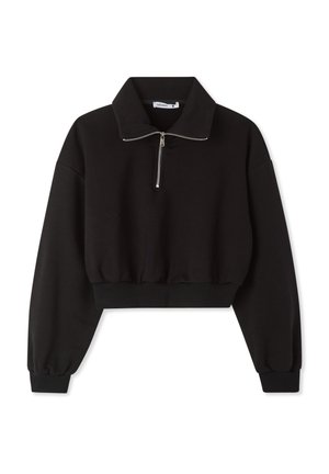 Felpa nera corta con collo alto, zip frontale e maniche larghe. Realizzata in tessuto morbido con fondo e polsini a coste.