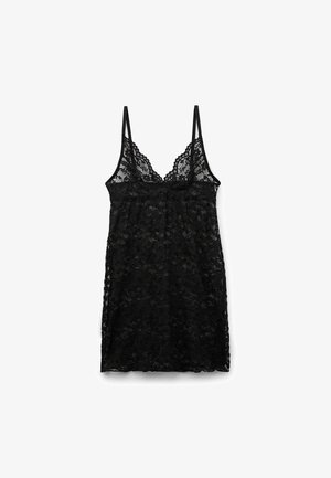 Czarna koronkowa koszulka na ramiączkach z cienkimi regulowanymi paskami, falbaniastym wykończeniem dekoltu, przewiewnym wzorem w kwiaty, luźnym krojem.