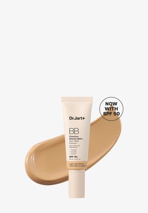 Tube de Dr.Jart+ BB Premium Beauty Balm avec un échantillon de fond de teint beige derrière et texte indiquant une protection SPF 50.